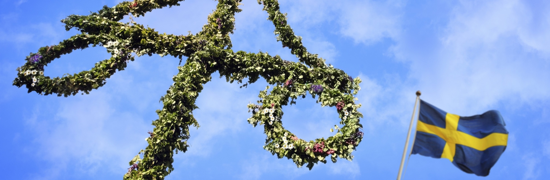 Maypole decorated with Swedish flag